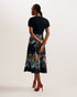 MAULINA-Dresses-MAULINA is made to flatter with its bias cut midi length and ponte bodice that create an elegant silhouette. This dress is fitted with a satin skirt that boasts a floral print, whilst the short sleeves come in a puff style for a touch of glam. Midi dress Ponte bodice Floral print satin skirt Short puff sleeves Crew neck Inverted V waist Bias cut Lydia is 5'10" / 1.77m and wears Black in a Ted size 1- Ted Baker Romania